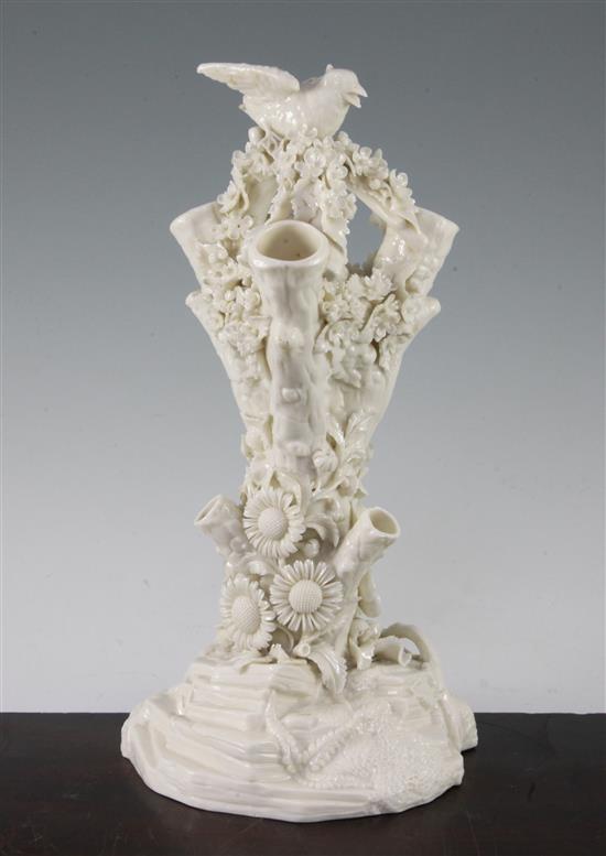 A Belleek bird and nest on a stump vase, late 19th century, 32cm, loss to bird